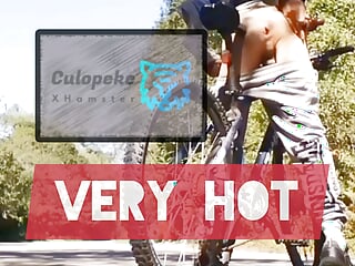 Handsome young man rides a bike with his butt plug on