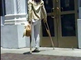 LAK Amputee Woman crutching on street