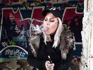 Blonde Lady Smokes An Electric Cigarette On Stairs