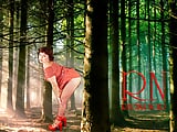 Pin-up lady posing in the forest. She shows her tits and pussy. Mesh tights. Special effect.
