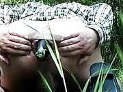 Outdoor anal - aubergine gape in a field by woodland