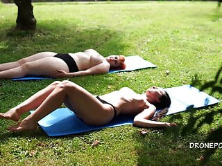 Two Naked Girls Sunbathing City Park...