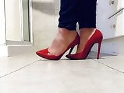 Playing in her red stilettos 
