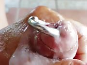 Wanking oiled pierced hard cock and cum
