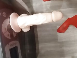 Realistic suction cup dildo on washing machine