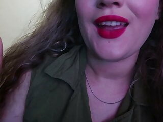 Cute woman paints her lips red...