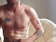 guy with tattoos and beard shoots a quick load