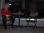 Crossdresser masturbating in front of hotel at night