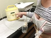 Pumping milk from tits in nursing bra