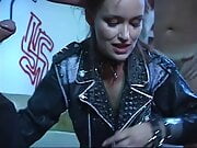 Rebellious young brunette in leather jacket sucks and takes two cocks