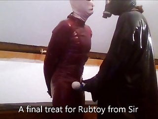 Rubtoy, In Latex Enjoying A Session On The Rack