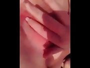 Redhead fingers her wet pussy