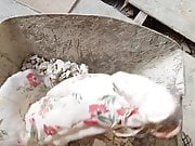 dumping floral dress in a construction trolley