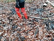 Red PVC thigh high boots and a mini skirt in mud!